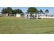 Well-maintained shuffleboard courts in a community setting, surrounded by green grass and trees at 9705 45Th N Way, Pinellas Park, FL 33782