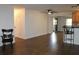 Open-concept living room with wood-look floors and an adjacent kitchen with a breakfast bar at 9705 45Th N Way, Pinellas Park, FL 33782