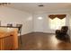 Inviting living room with wood-look floors, a recliner, and an open view of the front door at 9705 45Th N Way, Pinellas Park, FL 33782