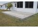 A charming patio with an updated paving stone pattern, and a view to a small tree in the side yard at 9705 45Th N Way, Pinellas Park, FL 33782