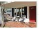 Inviting porch with seating area, swing, and colorful mosaic tile flooring at 9705 45Th N Way, Pinellas Park, FL 33782
