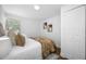 Bright bedroom featuring a plush bed, tasteful wall art, and a convenient closet at 4626 8Th S Ave, St Petersburg, FL 33711