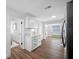 Bright kitchen featuring white cabinets, quartz countertops, stainless steel appliances, and modern laminate flooring at 4626 8Th S Ave, St Petersburg, FL 33711