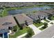 Aerial view of neighborhood with lake, mature trees and well-maintained landscaping at 10308 Malvasia Ave, Riverview, FL 33578