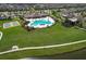 The aerial view shows a community pool, tennis courts, and playground at 10308 Malvasia Ave, Riverview, FL 33578