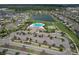 High-angle shot captures the community amenities, including a resort-style pool, tennis courts, and lakeside tranquility at 10308 Malvasia Ave, Riverview, FL 33578