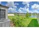 Serene water view from backyard with lush green grass and fruit trees at 10308 Malvasia Ave, Riverview, FL 33578