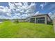 Enjoy the outdoors in this expansive backyard with a screened-in patio and pond view at 10308 Malvasia Ave, Riverview, FL 33578
