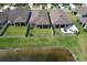 Aerial view of backyard with a screened lanai, white fence and pond access at 10308 Malvasia Ave, Riverview, FL 33578