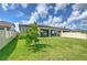 A well-maintained lawn and cozy screened patio enhance the backyard's appeal at 10308 Malvasia Ave, Riverview, FL 33578