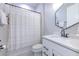 Bright bathroom featuring modern fixtures, a shower-tub combo, and a sleek white vanity at 10308 Malvasia Ave, Riverview, FL 33578