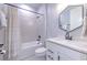 Bright bathroom featuring modern fixtures, a shower-tub combo, and a sleek white vanity at 10308 Malvasia Ave, Riverview, FL 33578
