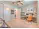 Neutral-toned bedroom with carpet, featuring an open door, a desk, and two closets at 10308 Malvasia Ave, Riverview, FL 33578