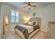 Comfortable bedroom featuring a large bed, window with shutters, full length mirror and side table at 10308 Malvasia Ave, Riverview, FL 33578