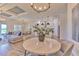 An elegant dining area showing the adjacent kitchen and living spaces in this open-concept home at 10308 Malvasia Ave, Riverview, FL 33578
