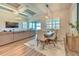 Open-concept dining area with wood floors, coffered ceiling, with adjacent living space and back yard access at 10308 Malvasia Ave, Riverview, FL 33578