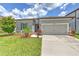 Charming single-story home featuring a two-car garage and a well-manicured lawn at 10308 Malvasia Ave, Riverview, FL 33578
