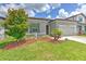 Charming single-story home with a well-manicured lawn and a two-car garage at 10308 Malvasia Ave, Riverview, FL 33578