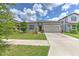 Charming single-story home featuring a well-manicured lawn and a welcoming two-car garage at 10308 Malvasia Ave, Riverview, FL 33578