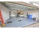 Spacious garage with epoxy flooring, featuring ample storage and parking space for a vehicle at 10308 Malvasia Ave, Riverview, FL 33578