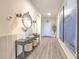 Entry hallway with a console table, decor, wood-look floors, and elegant lighting at 10308 Malvasia Ave, Riverview, FL 33578