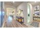 Hallway with modern art and decor, leading to an open-concept living space and the laundry room at 10308 Malvasia Ave, Riverview, FL 33578