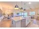 Open-concept kitchen with a large island, pendant lighting, connecting to dining and living areas at 10308 Malvasia Ave, Riverview, FL 33578