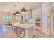 Modern kitchen featuring an island with sleek pendant lighting, breakfast bar and stainless steel appliances at 10308 Malvasia Ave, Riverview, FL 33578