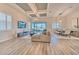 Spacious living room with wood floors, a coffered ceiling, and sliding glass doors with water view at 10308 Malvasia Ave, Riverview, FL 33578