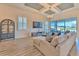 Bright living room featuring a coffered ceiling, wood floors, and sliding glass doors to the backyard at 10308 Malvasia Ave, Riverview, FL 33578