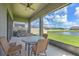Enjoy the serene backyard view from the screened-in patio, with a table and chairs for relaxing at 10308 Malvasia Ave, Riverview, FL 33578