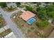 Aerial view displays a tile roof, screened-in pool, well-kept lawn, and landscape features at 11411 Terrell, Spring Hill, FL 34606