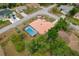 Bird's-eye view of home showing tile roof, screened-in pool, and mature landscaping at 11411 Terrell, Spring Hill, FL 34606