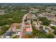 Aerial view shows property's neighborhood location, the home's tile roof, pool, landscaping and mature trees at 11411 Terrell, Spring Hill, FL 34606