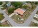Home features a tile roof, screened pool, landscaping, and a well-maintained yard, captured from above at 11411 Terrell, Spring Hill, FL 34606