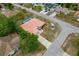 Aerial image displays home's pool, tile roof, neat landscaping, and beautiful trees at 11411 Terrell, Spring Hill, FL 34606