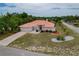 Aerial view of the home with a well-manicured lawn and a long driveway at 11411 Terrell, Spring Hill, FL 34606