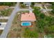 From above, home displays pool, tile roof, decorative rock and mulch beds, and mature trees at 11411 Terrell, Spring Hill, FL 34606