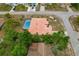 Aerial shot of home with a tile roof and screened pool amid mature landscaping and trees at 11411 Terrell, Spring Hill, FL 34606
