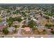 Aerial view displays home's setting within neighborhood, tile roof, screened pool, landscaping and mature trees at 11411 Terrell, Spring Hill, FL 34606