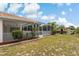 Private backyard featuring a screened-in pool enclosure, lush landscaping, and manicured lawn at 11411 Terrell, Spring Hill, FL 34606