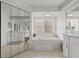 Bright bathroom with tub, shower, and large mirror at 11411 Terrell, Spring Hill, FL 34606