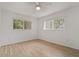 Bright bedroom with wood-look floors, ceiling fan, and large windows with view at 11411 Terrell, Spring Hill, FL 34606
