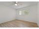 Bright bedroom with wood-look floors, ceiling fan, and large windows with view at 11411 Terrell, Spring Hill, FL 34606
