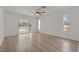 Bright bedroom with a ceiling fan, sliding glass doors, and laminate flooring at 11411 Terrell, Spring Hill, FL 34606
