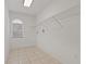 Walk-in closet with shelving, window, and tile floor at 11411 Terrell, Spring Hill, FL 34606
