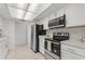 Modern kitchen with stainless steel appliances and ample cabinet space at 11411 Terrell, Spring Hill, FL 34606