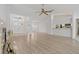 Open concept living room features wood floors, fireplace, and view of entry and kitchen at 11411 Terrell, Spring Hill, FL 34606