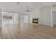 Open living room with wood floors, fireplace, and sliding doors leading to pool area at 11411 Terrell, Spring Hill, FL 34606