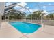 Beautiful pool enclosed with white screen and a clear blue sky above at 11411 Terrell, Spring Hill, FL 34606